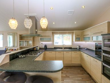 A kitchen with modern fixtures and appliances at The Hideaway in Pwllheli