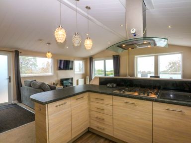 A kitchen with a stove and cabinets at The Hideaway in Pwllheli