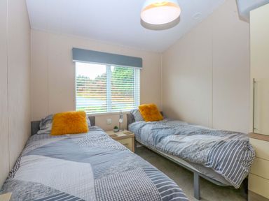 A bedroom with two beds and a window at The Hideaway in Pwllheli
