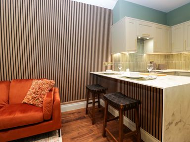 A kitchen with a sofa and countertop at The Studio in Windermere