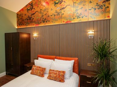 A bedroom with a bed and decorative elements at The Studio in Windermere