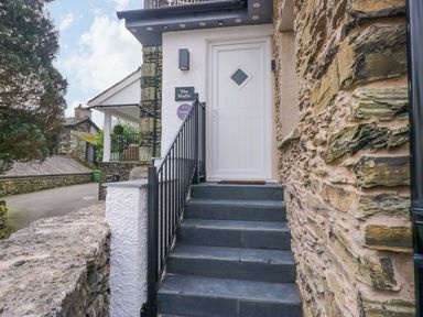 An entrance staircase with a door at The Studio in Bowness-On-Windermere