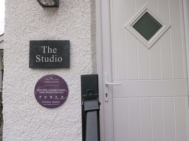 An entrance with a door and a name plaque at The Studio in Bowness-On-Windermere