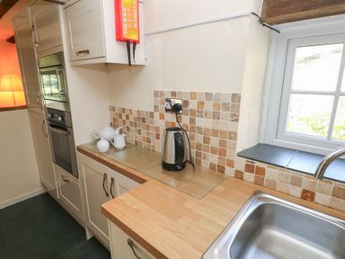 A kitchen with kettle and sink at Carthouse Cottage in Clarbeston Road