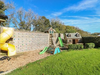 A play area with climbing wall and slide at Stable Cottage in Clarbeston Road