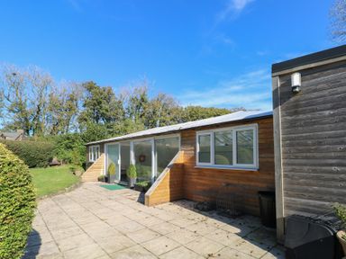 A building with windows and patio at Stable Cottage in Clarbeston Road