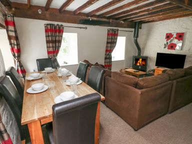 A dining room with a table set for dinner at Shippen Cottage Clarbeston Road