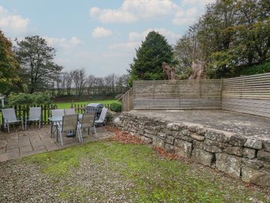 A garden with table and chairs and a grill at Shippen Cottage Clarbeston Road