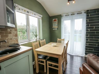 A dining room with a table and chairs at Harbour Lights in Holyhead