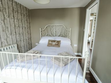 A bedroom with a bed and radiator at Harbour Lights Holyhead