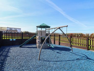 A playground with a slide and swing at Ocean Terrace 28 Mullacott Ilfracombe
