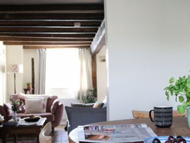 A living room with a table and mug at The Old Post Box in 
