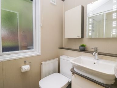 A bathroom with a sink and toilet at Feather Hill Lodge in Windermere