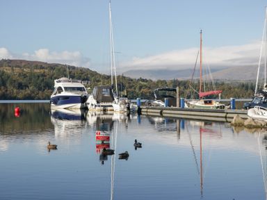 A marina with boats and ducks at Feather Hill Lodge White Cross Bay near Troutbeck Bridge