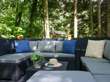 An outdoor seating area with a sofa and table at Feather Hill Lodge White Cross Bay, Skiptory Howe 38