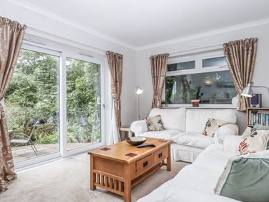 A living room with a sofa and coffee table at Mayflower View in Dawlish