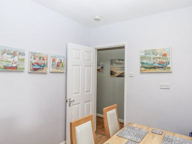 A dining room with a table and chairs at Mayflower View in Dawlish