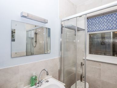 A bathroom with a shower and sink at Mayflower View in Dawlish