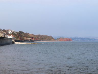 A beach landscape with cliffs and houses at Mayflower View in Dawlish