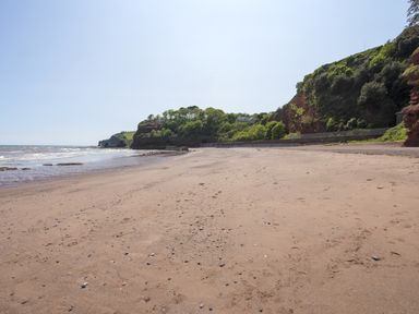 A beach with sand and water at Mayflower View in Dawlish