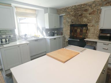 A kitchen with cabinets and a countertop at Pedn Brose Near Mousehole