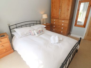 A bedroom with a bed and wardrobe at Pedn Brose near Mousehole