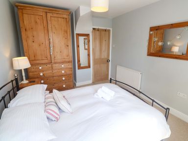 A bedroom with a bed and wardrobe at Pedn Brose Near Mousehole