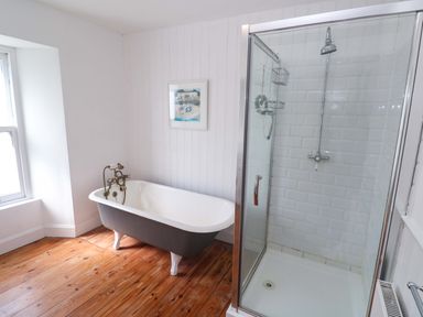 A bathroom with a bathtub and shower at Pedn Brose Near Mousehole
