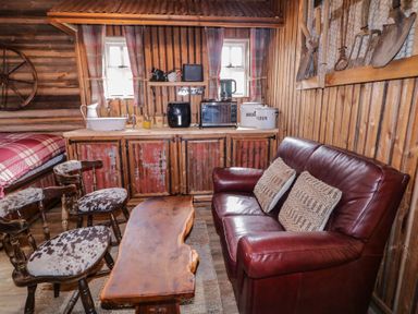 A living room with a sofa and coffee table at Rusty Barn in Limavady