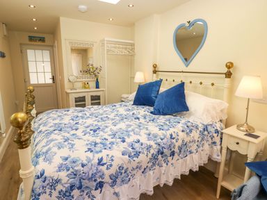 A bedroom with a bed and nightstand at Sea Folly