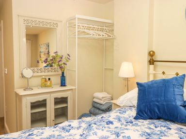 A bedroom with a bed and a dresser at Sea Folly 