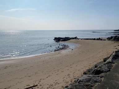 A beach with rocks and sea at Sea Folly in Porthcawl