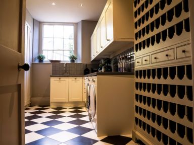 A kitchen with cabinets and a washing machine at St Anne's Manor in Torquay