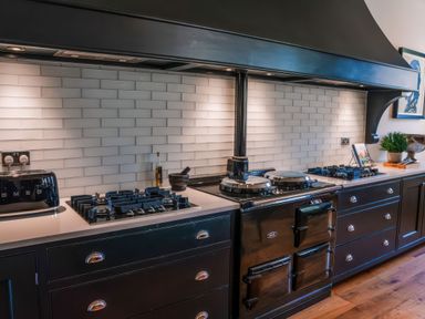 A kitchen with a gas stove and sink at St Anne's Manor in Torquay