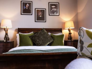 A bedroom with a bed and decorative pillows at St Anne's Manor in Torquay