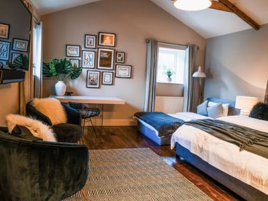 A bedroom with a bed, chair, and desk at St Anne's Manor in Torquay