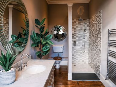 A bathroom with a sink, toilet, and shower at St Anne's Manor, Torquay