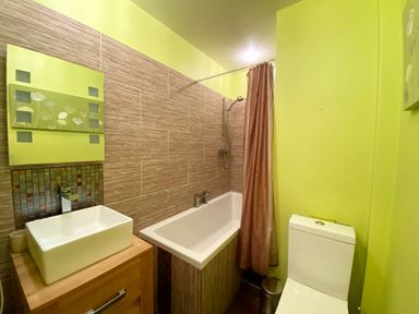 A bathroom with a sink, bathtub, toilet, and shower at Upper Stable - The Stables Apartments at Meadfoot Bay in Torquay