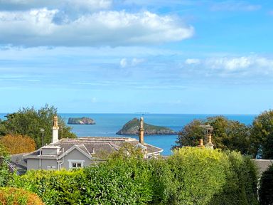 A view of the sea and islands with houses and trees at Upper Stable - The Stables Apartments at Meadfoot Bay, Torquay