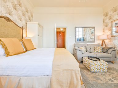 A bedroom with a bed and couch at Muntham - Studio Apartment 7 Torquay