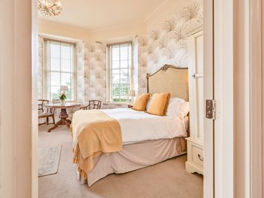 A bedroom with a bed and table at Muntham - Studio Apartment 7 Torquay