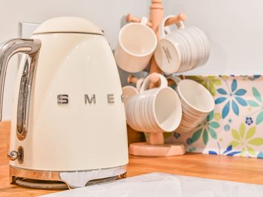 A kettle and cups on a kitchen counter at Muntham - Studio Apartment 7 in Torquay