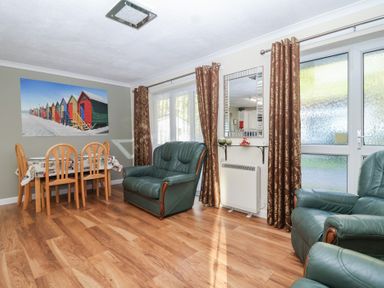 A living room with a dining area and seating at Willow Lodge Rosecraddoc Lodge near Liskeard