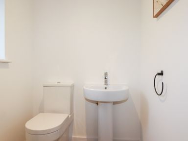 A bathroom with a toilet and sink at Barn 5