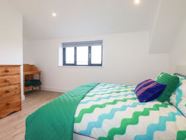 A bedroom with a bed and a dresser at Barn 5