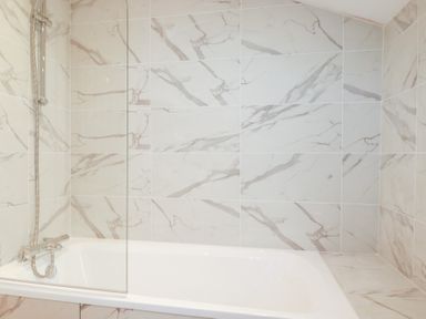 A bathroom featuring a bathtub and a shower at Barn 5