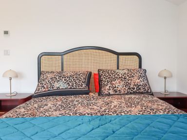 A bedroom with a bed and lamps at Barn 5