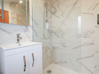 A bathroom with a shower and sink at Barn 5