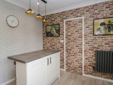 A kitchen with a countertop and pendant lights at Apple Byrd in Kendal