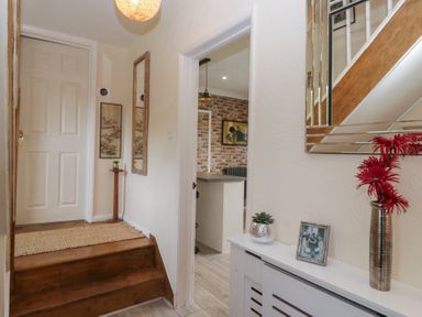 A hallway with a staircase and decorative elements at Apple Byrd in Kendal
